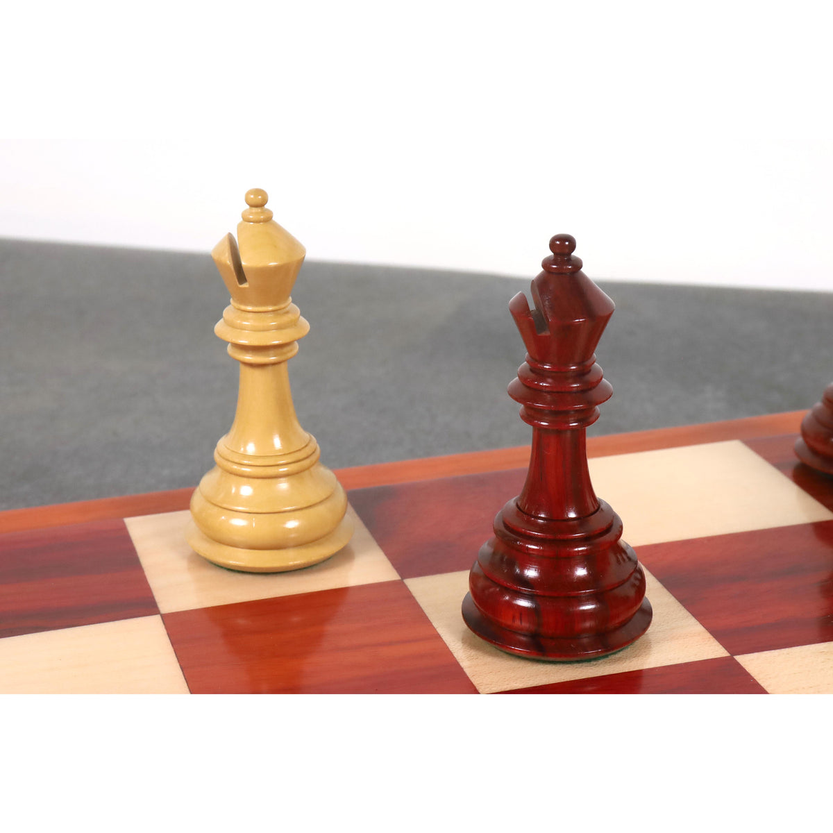Two triple weighted luxury bishop chess pieces in contrasting boxwood and bud rosewood.