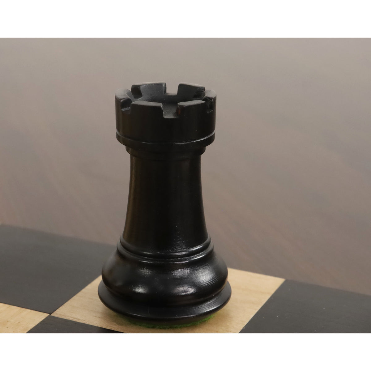 Ebonised boxwood Rook showing the detailed crenellations and Professional Staunton design.