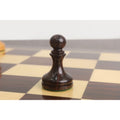 Close-up of the dark rosewood pawn from the 3.8" Candidates Series minimalist chess set on a wooden board.