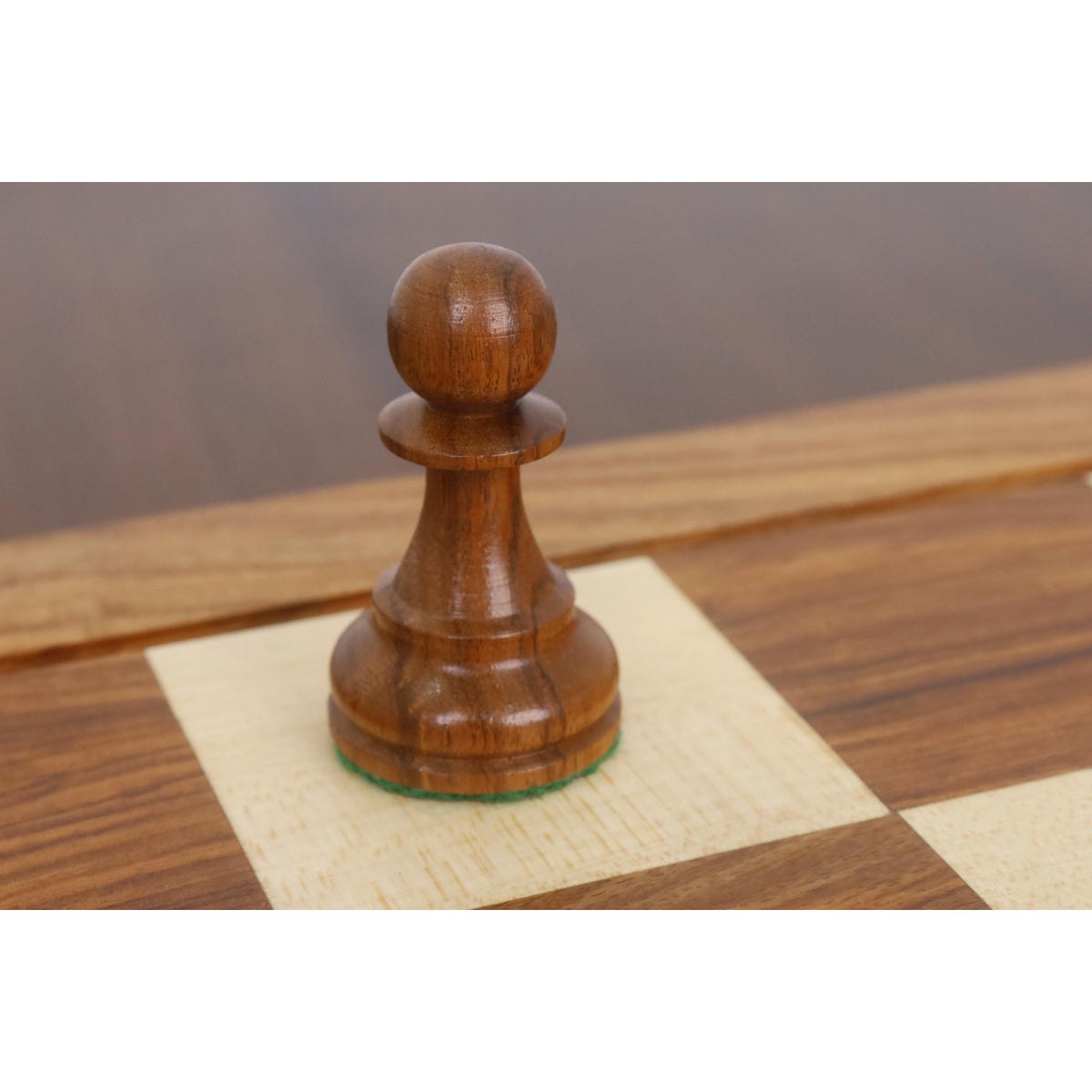 A detailed view of a single Golden Rosewood pawn from a Leningrad Staunton chess set.