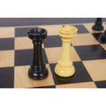 Ebony and boxwood rook chess pieces displayed on a wooden chessboard.