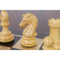 Close-up of a premium boxwood knight chess piece on a wooden board.