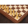 Close-up of light boxwood Staunton style magnetic chess pieces on a wooden travel board.