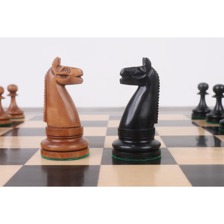 Close-up of hand-carved antiqued and ebonized boxwood Knights on a checkered chess board.