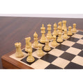 Natural boxwood magnetic chess pieces arranged on the maple and ebony wooden folding board.