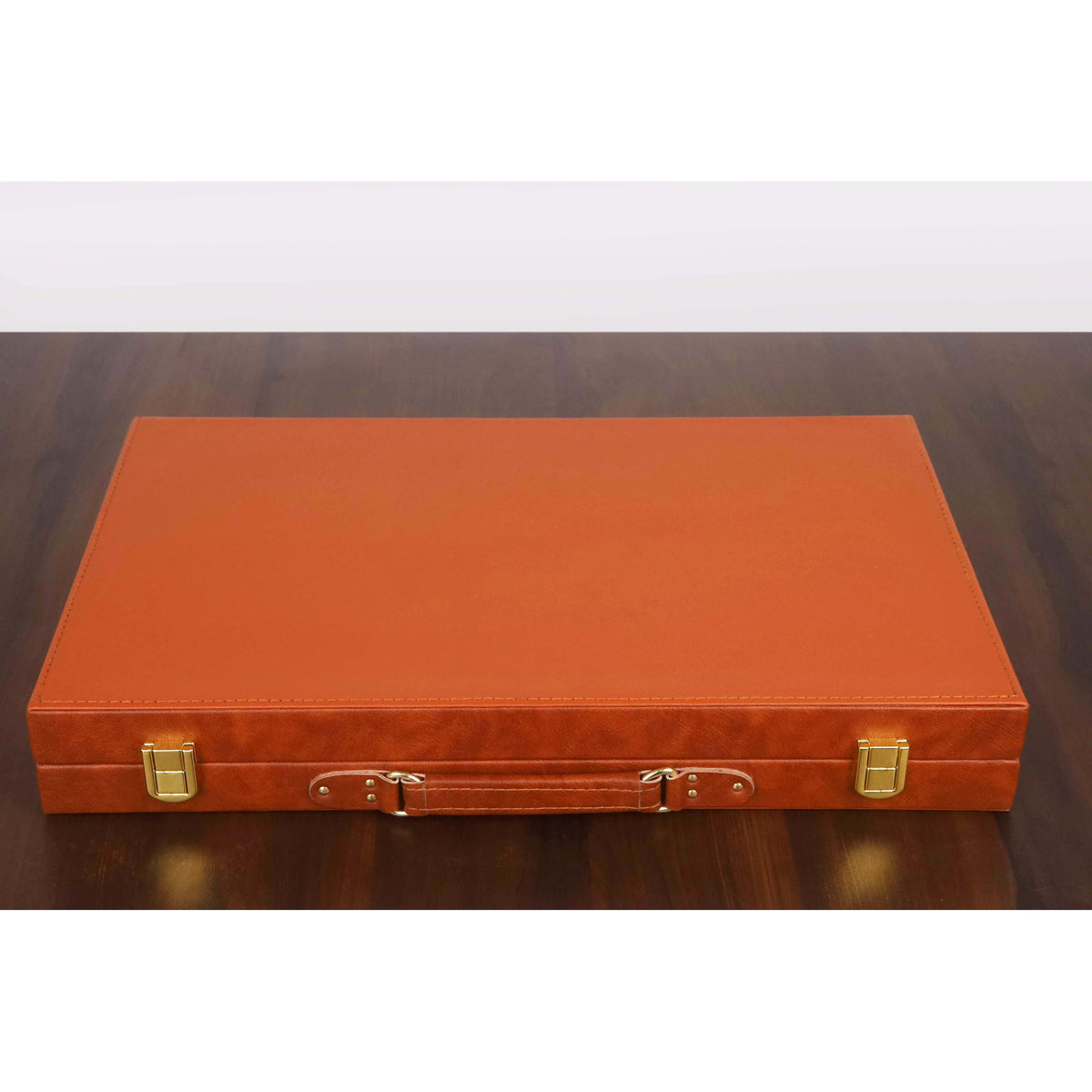 Front view of the closed cognac brown backgammon case highlighting the carry handle and secure brass latches.