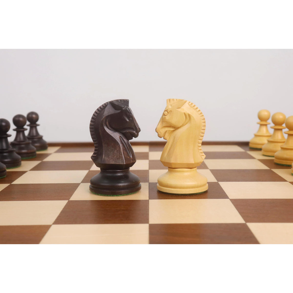 Close-up of hand-carved Dubrovnik style knights in ebonized boxwood and natural boxwood.