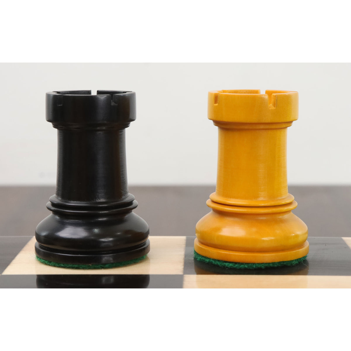 Side-by-side view of ebonized and antiqued boxwood Rooks from the Dubrovnik chess series.