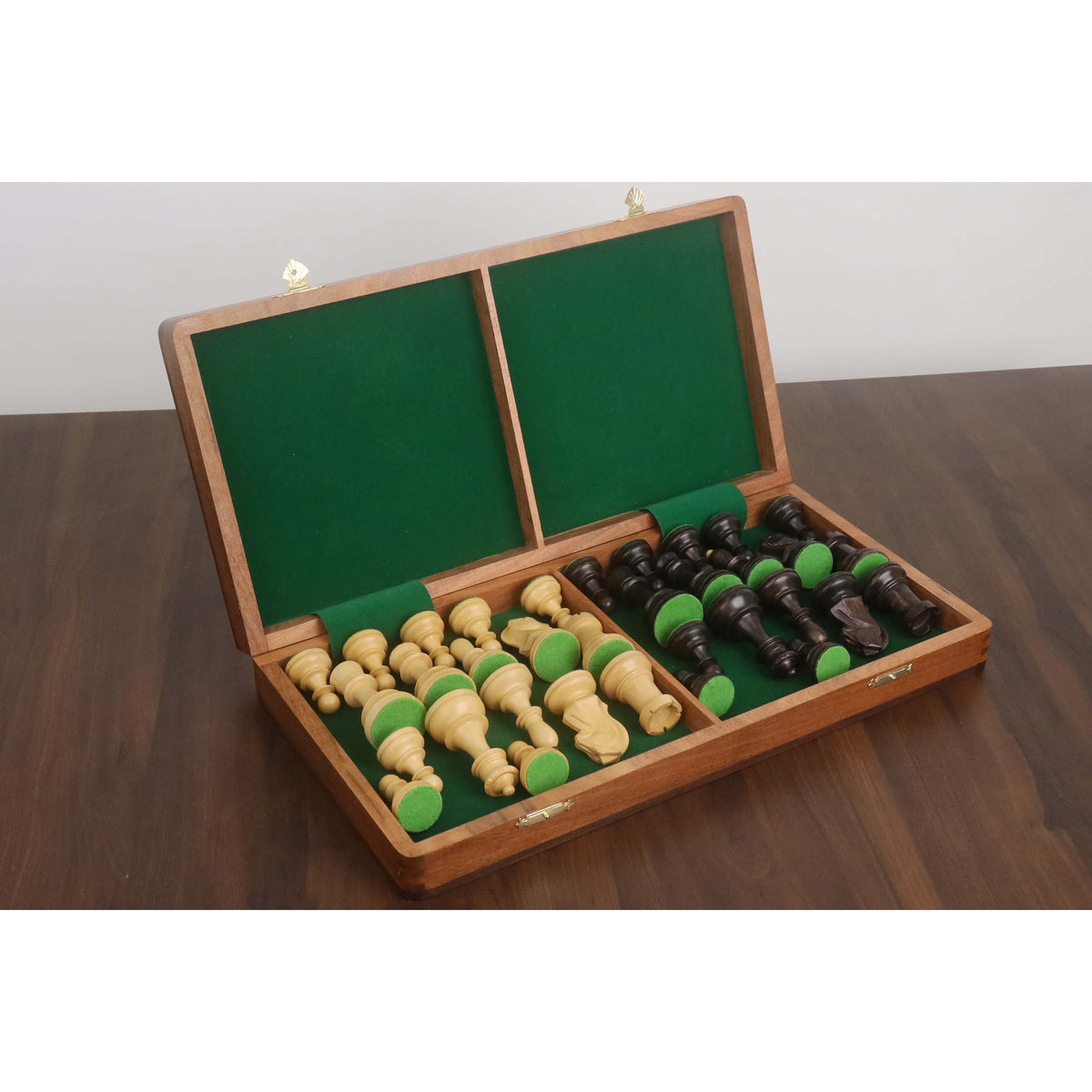 Interior of a green felt-lined folding chess board showing secure storage for Dubrovnik style pieces.
