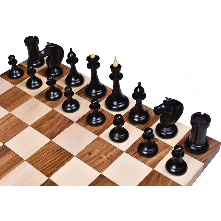 Ebonised boxwood Soviet Latvian chess pieces with slim stems arranged on a wooden chess board.