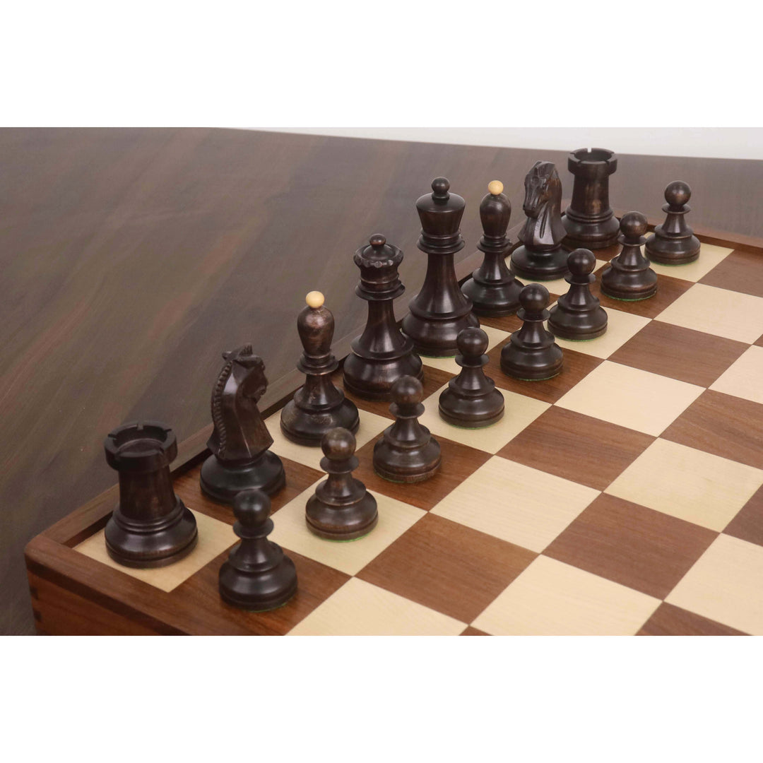 Ebonized boxwood 1950s Fischer Dubrovnik chess pieces arranged on a wooden folding chess board.