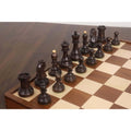 Ebonized boxwood 1950s Fischer Dubrovnik chess pieces arranged on a wooden folding chess board.