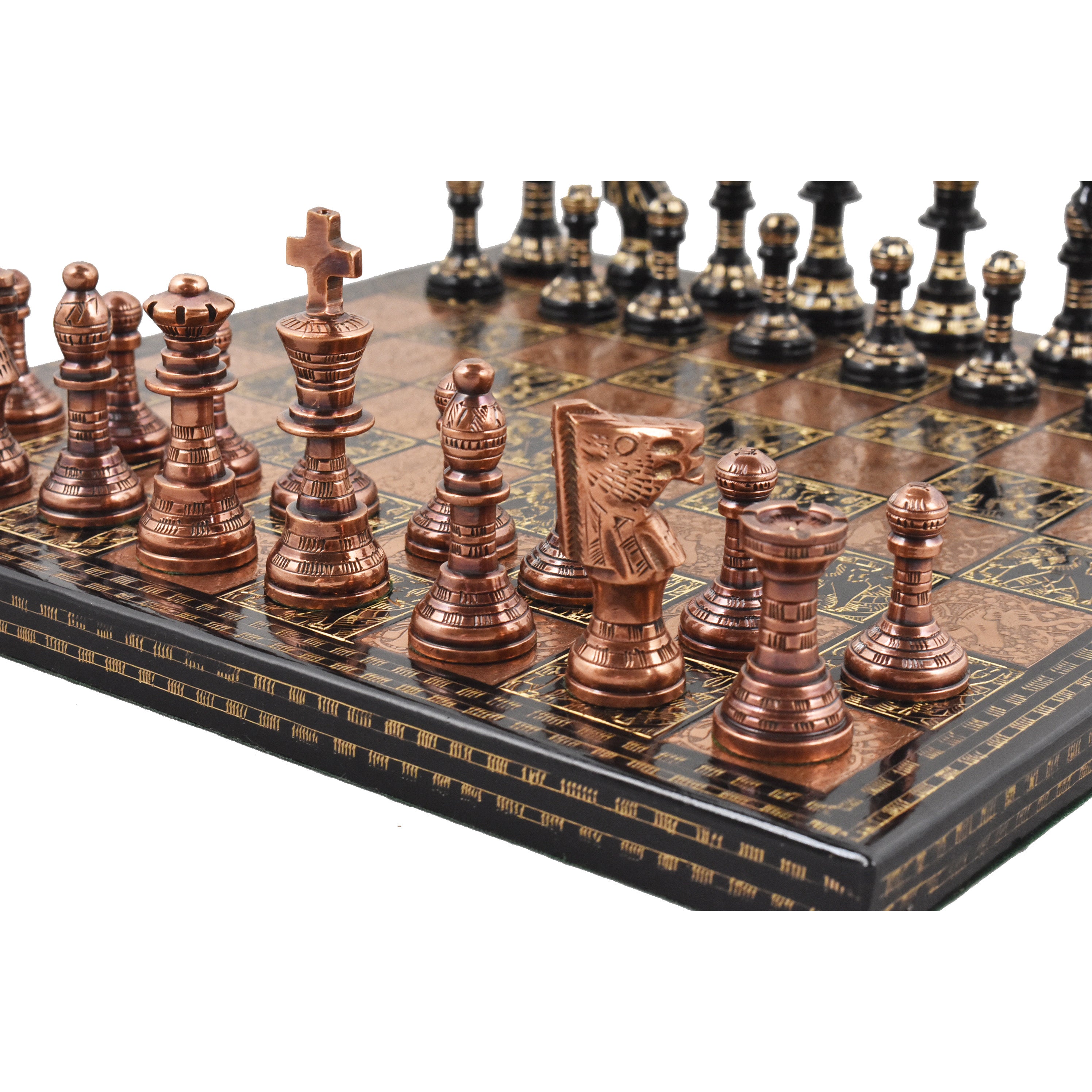 Luxury French Staunton copper and black chess pieces arranged on an etched brass board.