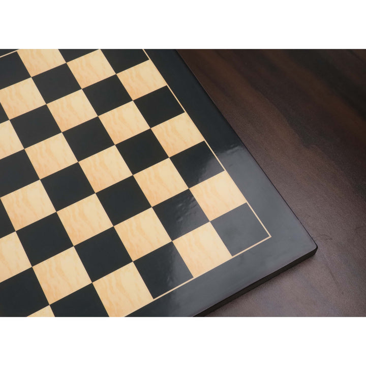 Glossy surface of an ebony and maple wood printed chess board reflecting light on 45mm squares.
