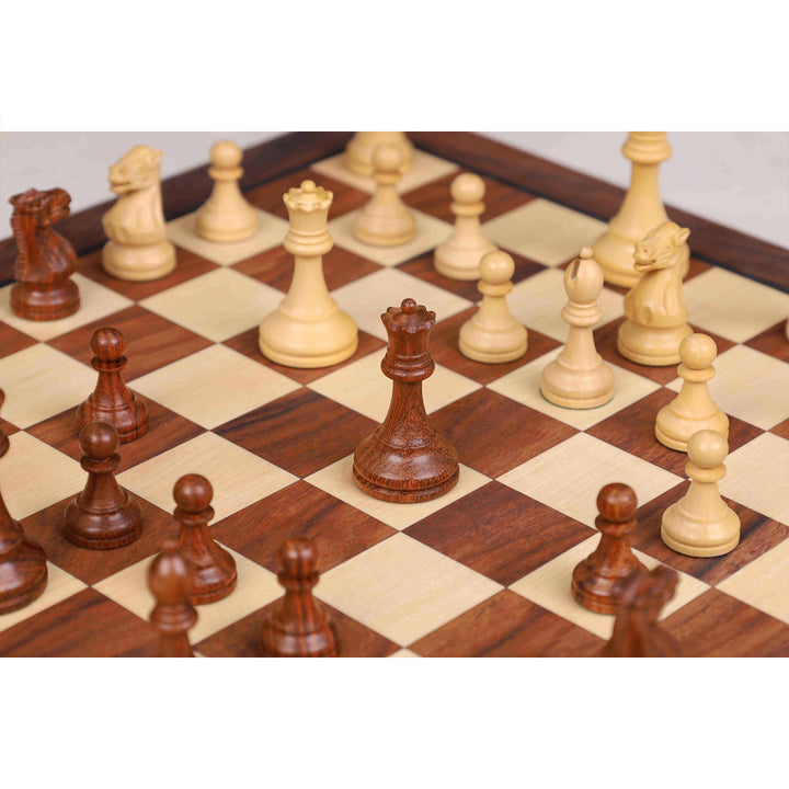Focused view of a carved golden rosewood magnetic queen on a wooden travel chess board.