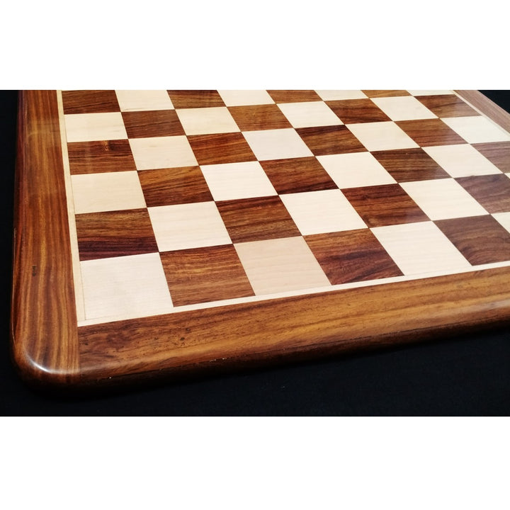 Detailed perspective of the wood grain on a golden rosewood and maple inlaid wooden chess board.