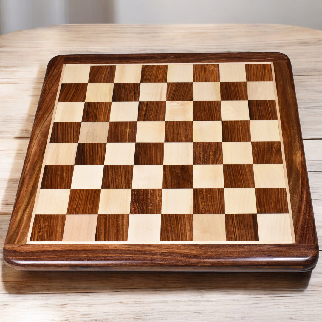17 inch golden rosewood and maple wood inlaid chess board with 45 mm squares on a wooden tabletop.