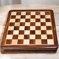17 inch golden rosewood and maple wood inlaid chess board with 45 mm squares on a wooden tabletop.