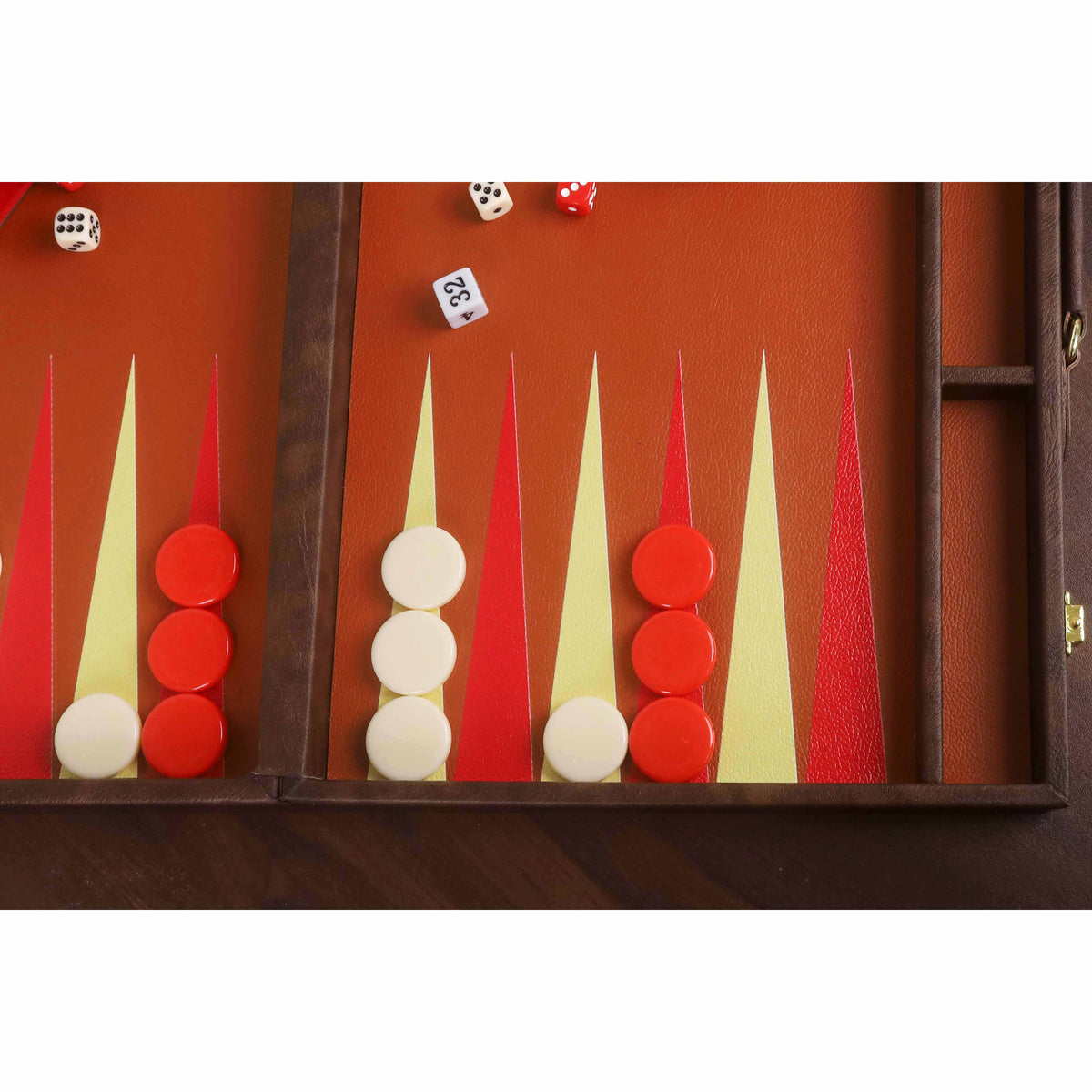 Close-up of textured leatherette backgammon board surface with red and cream playing points and chips.