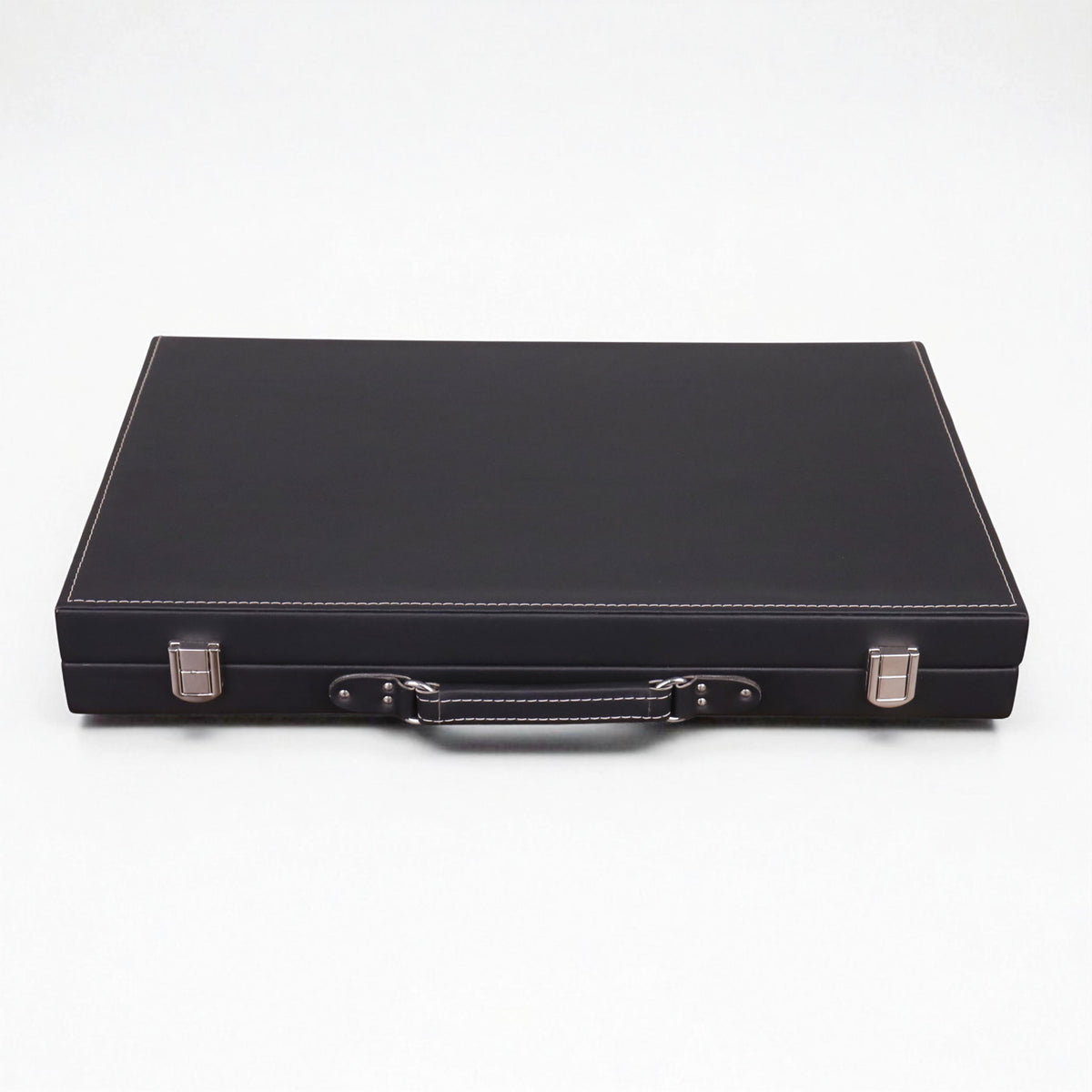 Closed luxury backgammon briefcase in ebony black leatherette with premium stitching and silver clasps.