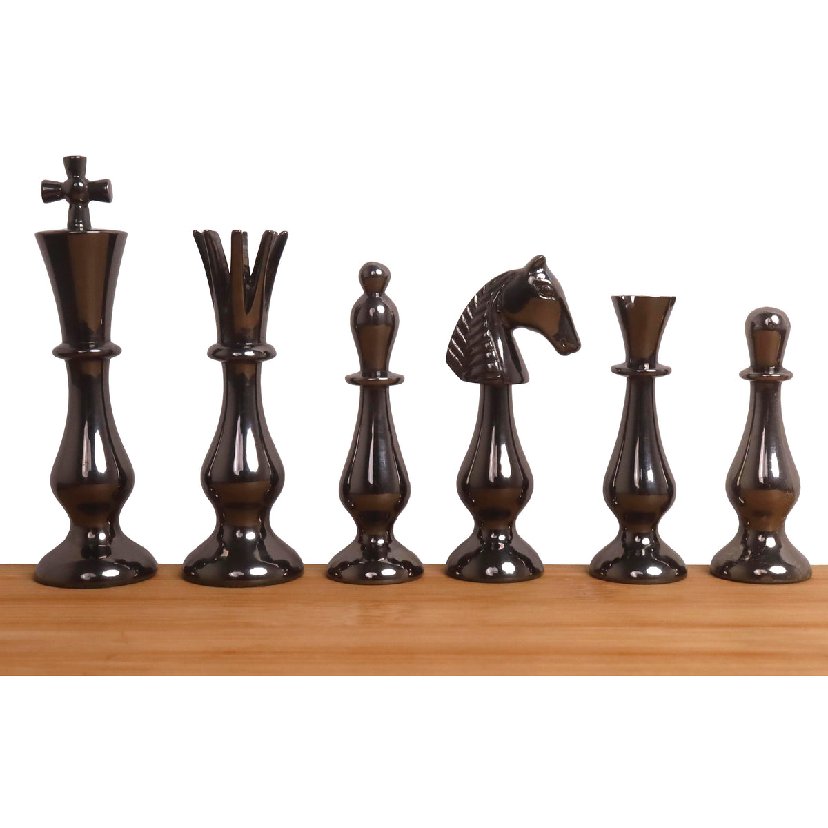 Black minimalist brass chess pieces including King, Queen, and Knight on a wooden base.