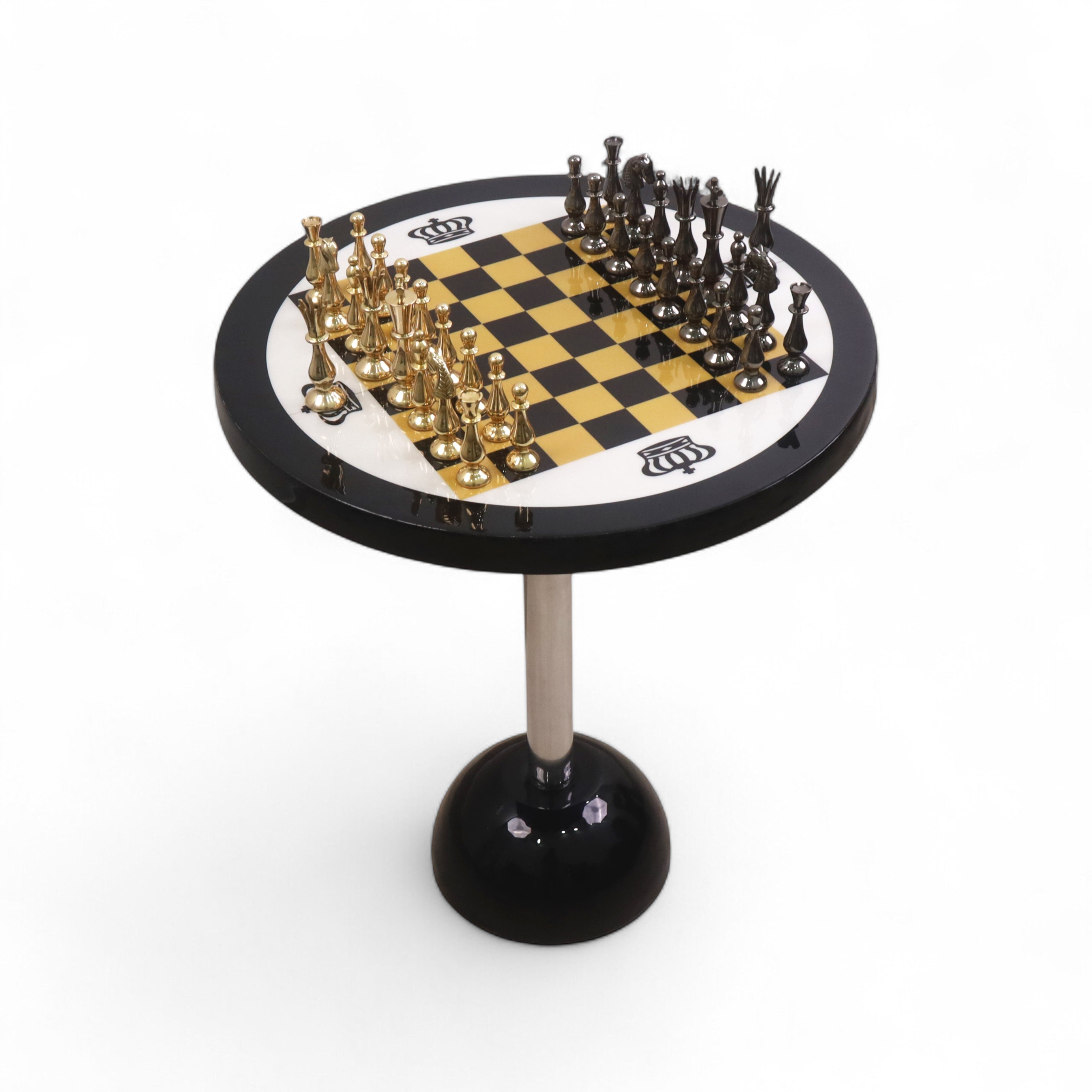 Full view of a 17 inch minimalist brass chess set on a 21 inch high black pedestal table.