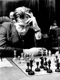 Grandmaster Yuri Averbakh playing with a classic Soviet-style chess set.
