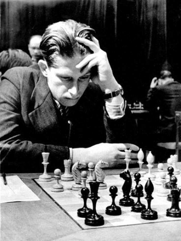 Grandmaster Yuri Averbakh playing with a classic Soviet-style chess set.