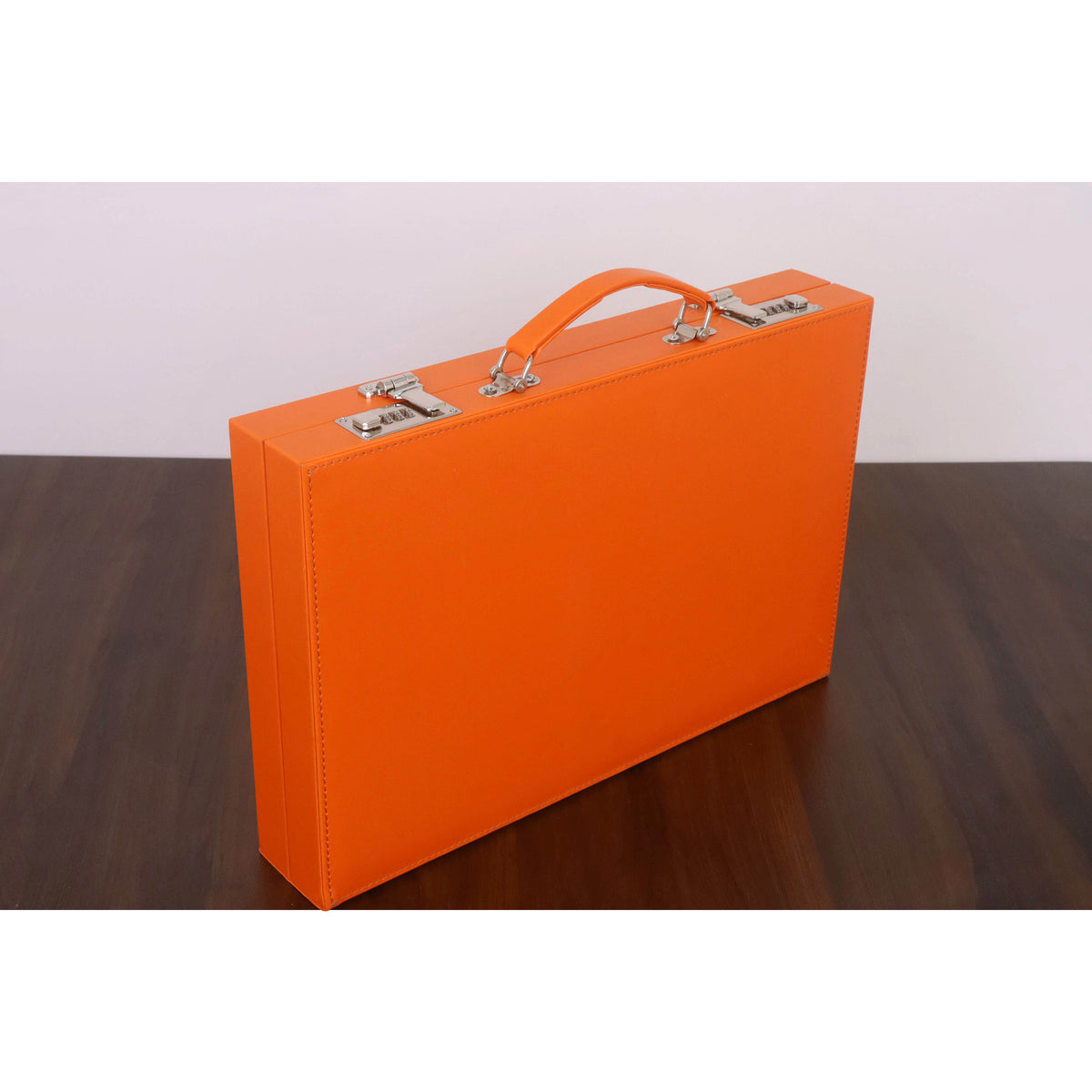 Side view of an orange leatherette backgammon briefcase showcasing secure dual silver combination locks.