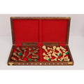 Opened folding wooden chess board with a vibrant red felt interior storing golden rosewood and acrylic ivory pieces.
