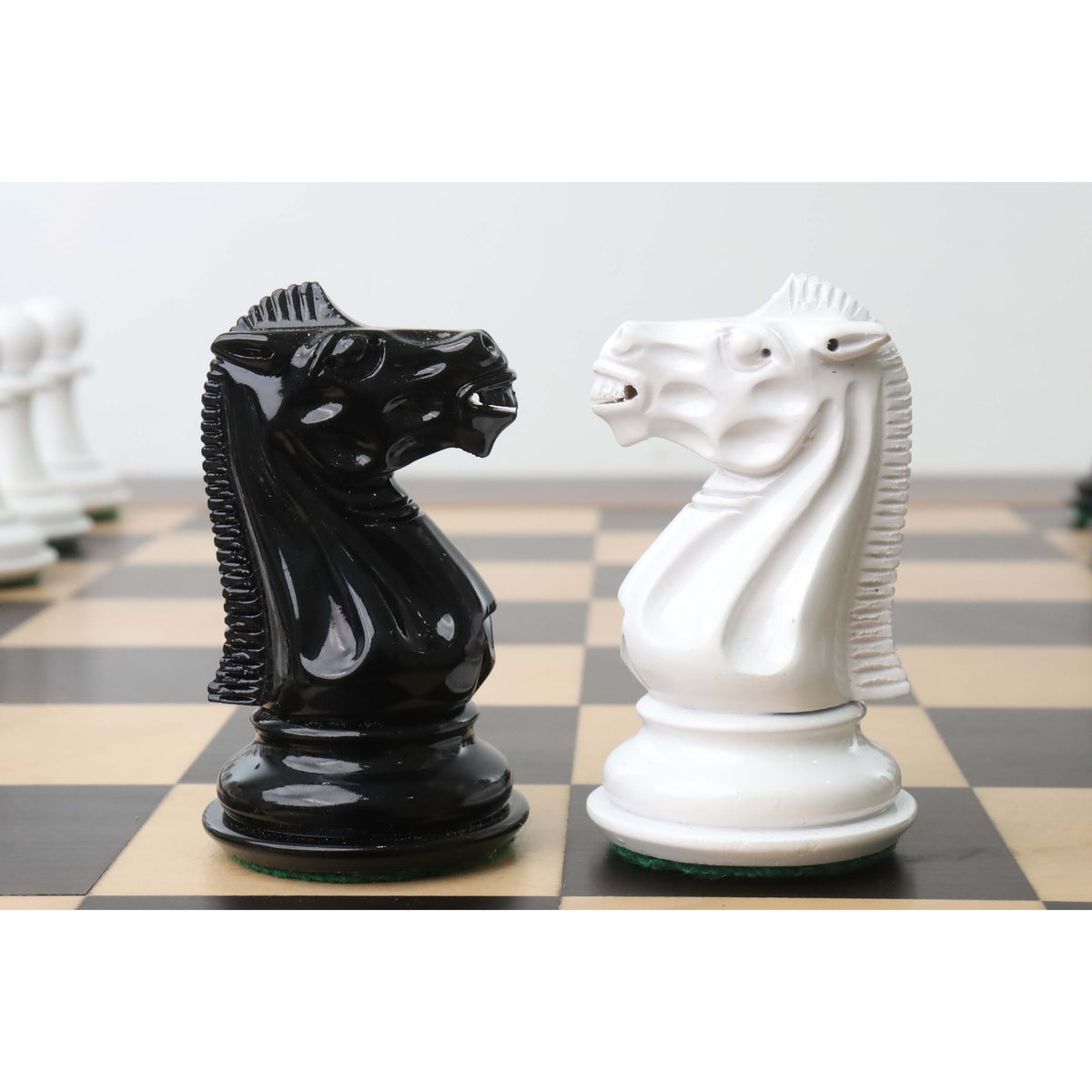 Profile view of hand-carved black and white lacquer knights from the 1940s Soviet reproduction set.