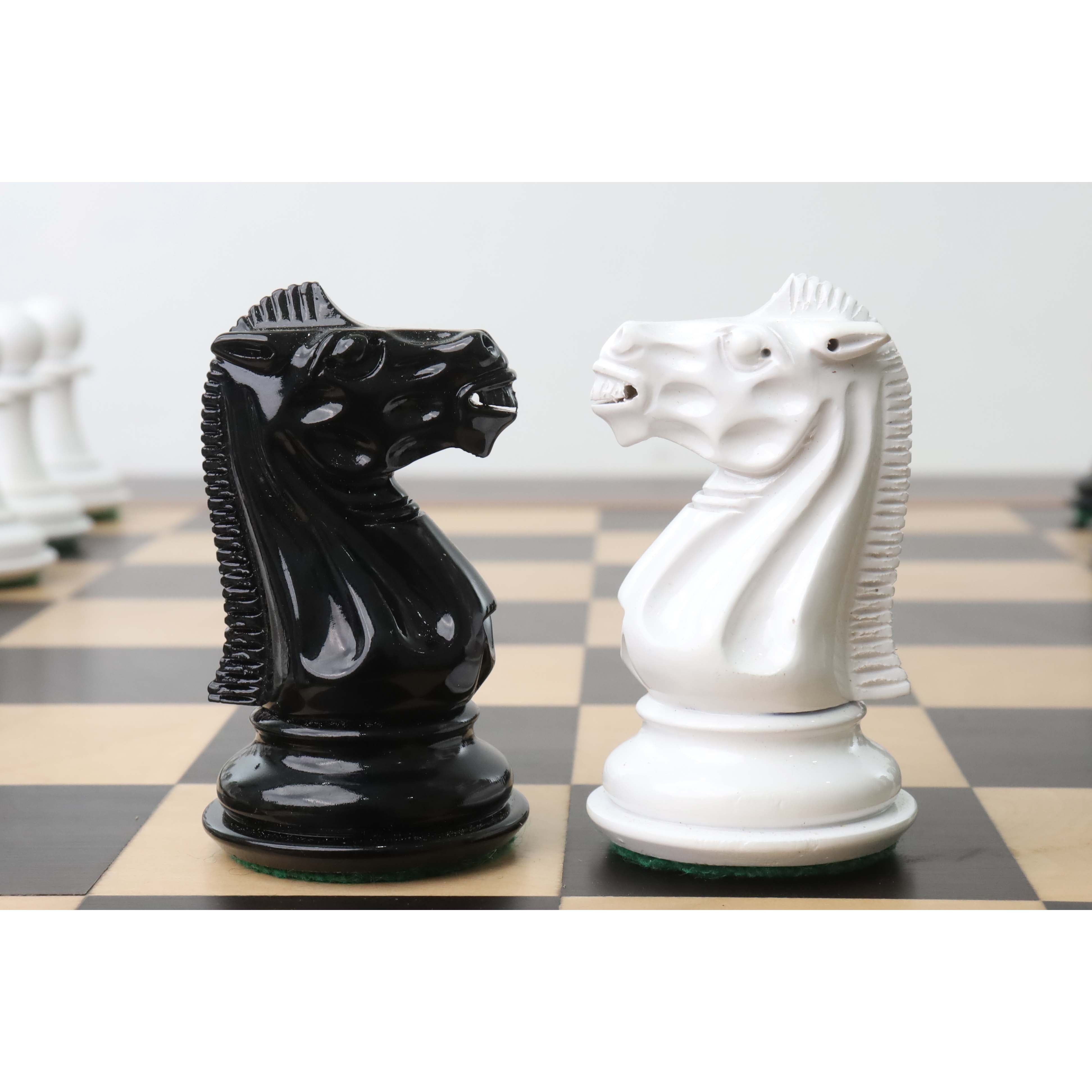 Profile view of hand-carved black and white lacquer knights from the 1940s Soviet reproduction set.