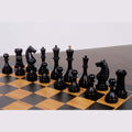 Ebonised boxwood Soviet chess pieces from the 1935 Botvinnik Flohr-II set arranged on a board.