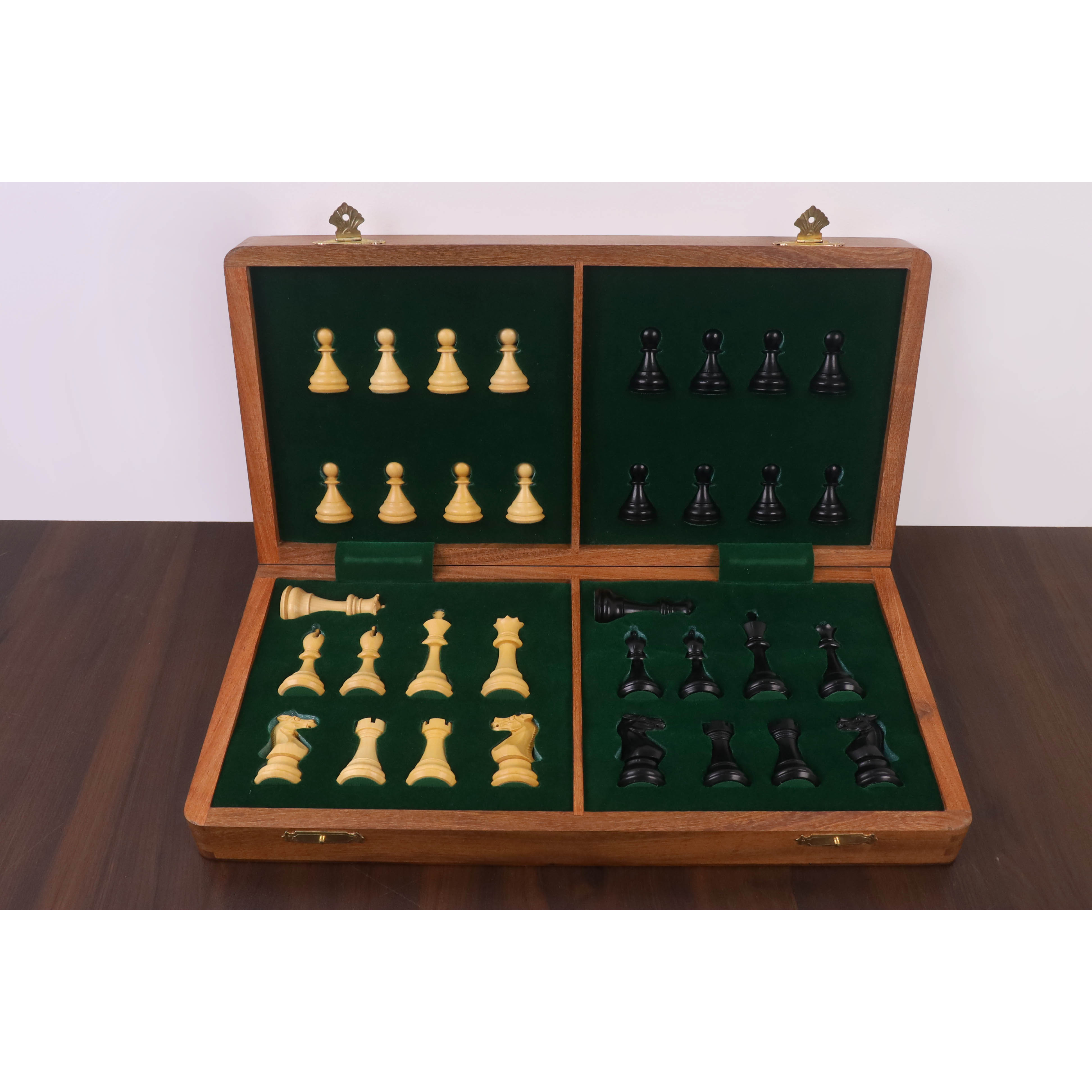 Green felted interior of a wooden chess box with custom storage slots for ebonized and boxwood pieces.