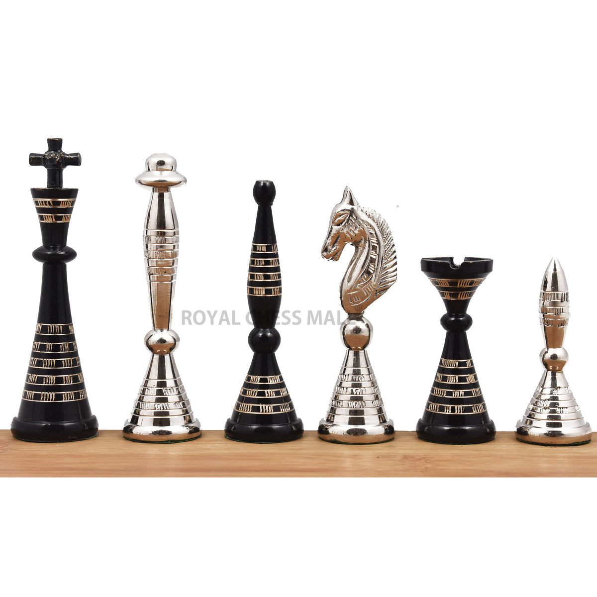 Complete set of solid brass black and silver Warli art chess pieces in a studio view.