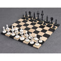 Complete set of white and black camel bone Victorian era pre-Staunton chess pieces set up for play on a wooden board.