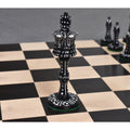 Victorian Black dyed camel bone Victorian era pre-Staunton king piece resting on a wooden chessboard.Pre Staunton Chess Pieces Only Set