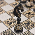 Macro close-up of a black brass Warli art knight piece on a luxury metal board.