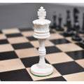 White camel bone Victorian era pre-Staunton king piece featuring intricate carvings on a wooden chess board.