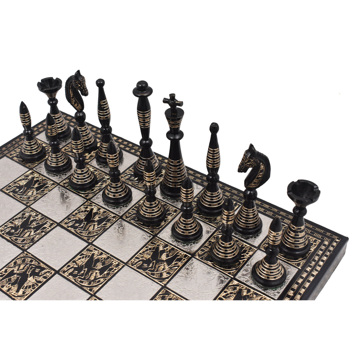 Overhead view of the black brass Warli art chess army arranged on the board.