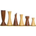 Minimalist Tower Series chess pieces lined up by height, alternating between golden rosewood and natural boxwood finishes.
