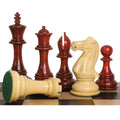 Bud rosewood luxury Staunton chess pieces lined up on a board with a boxwood rook showing its green felt base.