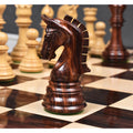 Close-up of a dark rosewood Imperial Staunton knight standing on a glossy chessboard.