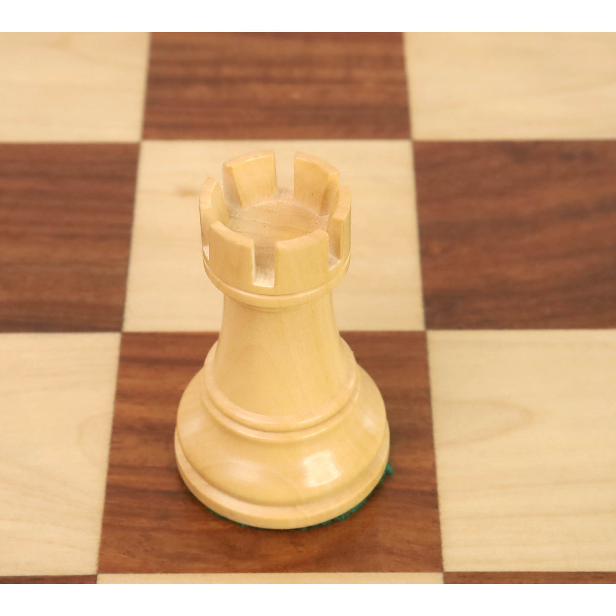 Detailed top view of a boxwood rook piece from the New Classic Staunton weighted wooden chess set.