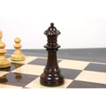 Dark Anjan rosewood Pinney Staunton Queen chess piece standing on a polished wooden chessboard.