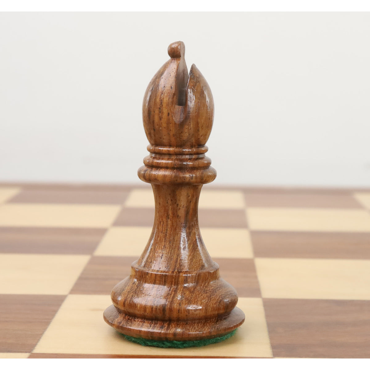 Golden Rosewood bishop chess piece displaying a detailed carved miter top.