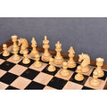 Complete army of boxwood Carvers Art chess pieces set up on a glossy wooden board.