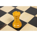 A single antiqued boxwood rook piece from the French Chavet chess set.