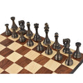 Antique brass metal luxury chess pieces arranged on a wooden chessboard.