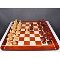 Overhead layout view of 4.4 inch Dragon Staunton luxury chess pieces on a large bordered wooden chessboard.